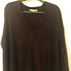 Sweater buttons up the front + opens on both sides